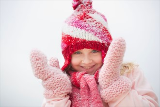 Portrait of smiling girl (8-9) wearing winter clothing.