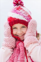 Portrait of smiling girl (8-9) wearing winter clothing.