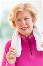 Portrait of smiling senior woman with towel.