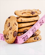 Stack of chocolate chip cookies with measure tape.