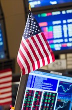 American flag on trading desk.