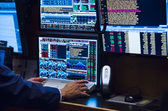 Stock trader working on computer.