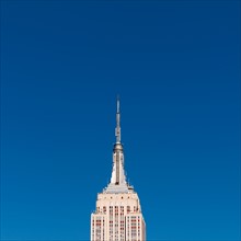 USA, New York, New York City, Empire State Building against blue sky.