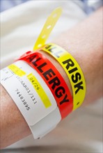 Close up of patient's hand with information wrist bands.