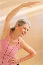 Portrait of senior woman exercising in gym.