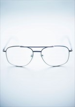 Close up of glasses on blue background, studio shot.