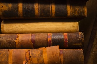 Close up of antique books in leather covers, studio shot.