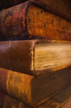 Close up of antique books in leather covers, studio shot.