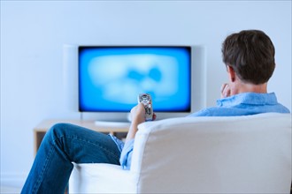 Man watching tv in living room.