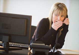 Business woman on landline phone.