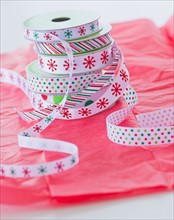 Stack of colorful ribbons on wrapping paper. Photo : Daniel Grill