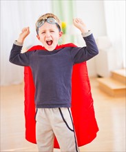 Portrait of boy (6-7) wearing superhero costume. Photo : Daniel Grill