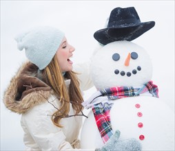 Profile of young woman with snowman. Photo : Daniel Grill