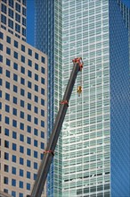 Usa, New York State, New York City, crane's hook in front of skyscraper. Photo : fotog