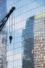 Usa, New York State, New York City, crane's hook and glass` reflection in skyscraper. Photo : fotog