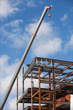 Part of construction frame and crane. Photo : fotog