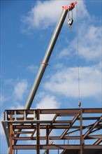 Part of construction frame and crane. Photo : fotog