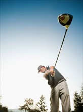 USA, California, Mission Viejo, Low angle view of man playing golf.