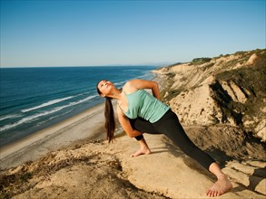 USA, California, San Diego, Woman practicing yoga on beach.