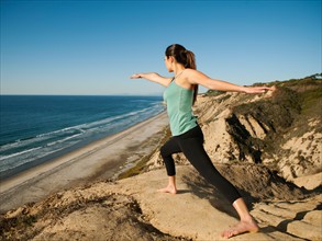USA, California, San Diego, Woman practicing yoga on beach.