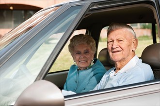 Portrait of senior couple in car.