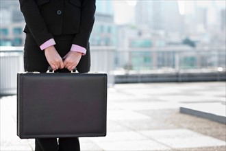 USA, Seattle, Midsection of businesswoman holding briefcase. Photo : Take A Pix Media