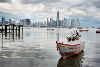 Panama, Panama City, Fishing boat with skyline in background. Photo : DreamPictures