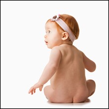 Rear view of baby girl (6-11 months), studio shot. Photo : Mike Kemp