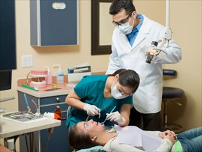 Dentists and patient in dental surgery. Photo : Dan Bannister