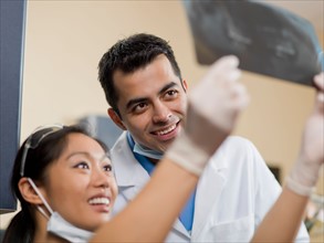 Dentists checking x-ray image. Photo : Dan Bannister