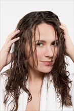 Portrait of smiling woman with wet hair, studio shot. Photo : Jan Scherders