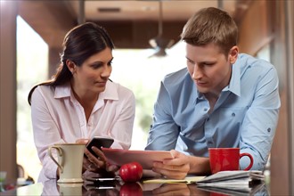 Couple looking at tablet pc. Photo : db2stock