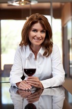 Portrait of woman with glass of wine. Photo : db2stock