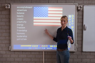 Teacher giving instructions at digital board. Photo : Mark de Leeuw