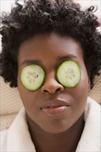 Woman with cucumber slices on eyes. Photo : Rob Lewine