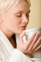 Woman enjoying cup of tea. Photo : Rob Lewine
