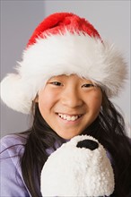 Portrait of girl wearing santa hat. Photo : Rob Lewine