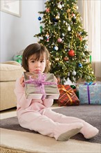 Portrait of girl with presents at Christmas morning. Photo : Rob Lewine