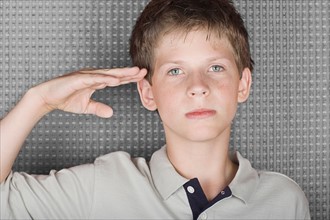Portrait of saluting boy. Photo : Rob Lewine