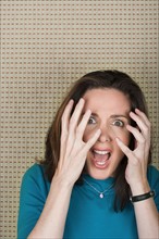 Studio portrait of mature woman screaming. Photo : Rob Lewine