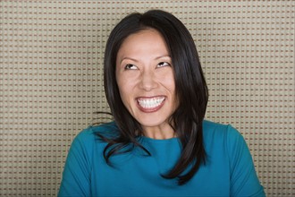 Studio portrait of mid adult woman laughing. Photo : Rob Lewine