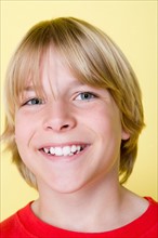 Studio portrait of teenage (16-17) boy smiling. Photo : Rob Lewine