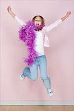 Studio portrait of teenage (16-17) girl jumping. Photo : Rob Lewine