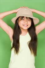 Studio shot portrait of teenage girl with hat, waist up. Photo : Rob Lewine