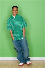 Studio shot portrait of young man with hands in pocket, full length. Photo : Rob Lewine