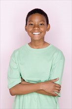 Studio shot portrait of young man with crossed arms, waist up. Photo : Rob Lewine