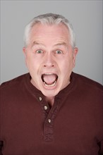 Studio portrait of scared senior man. Photo : Rob Lewine