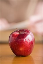 Red apple on desk. Photo : Rob Lewine