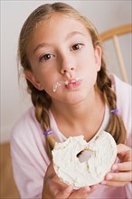 Portrait of girl (12-13) eating cake. Photo : Rob Lewine