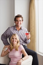 Portrait of smiling couple at home party. Photo : Rob Lewine